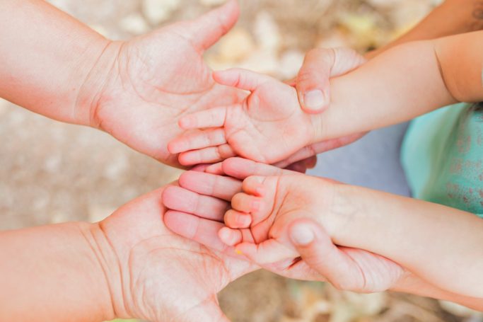 Mains de bébé dans les mains de ses parents